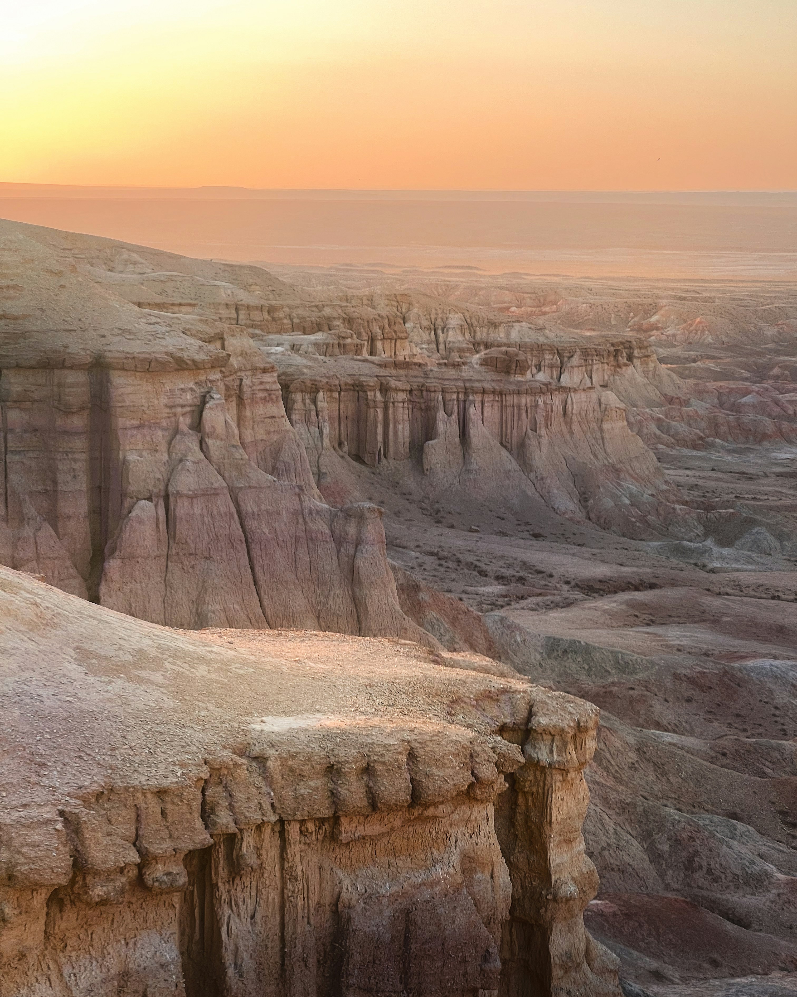 Tsagaan Suvarga, or White Stupa, is a striking geological formation in Mongolia's Gobi Desert, featuring towering limestone cliffs with distinctive white and red layers.