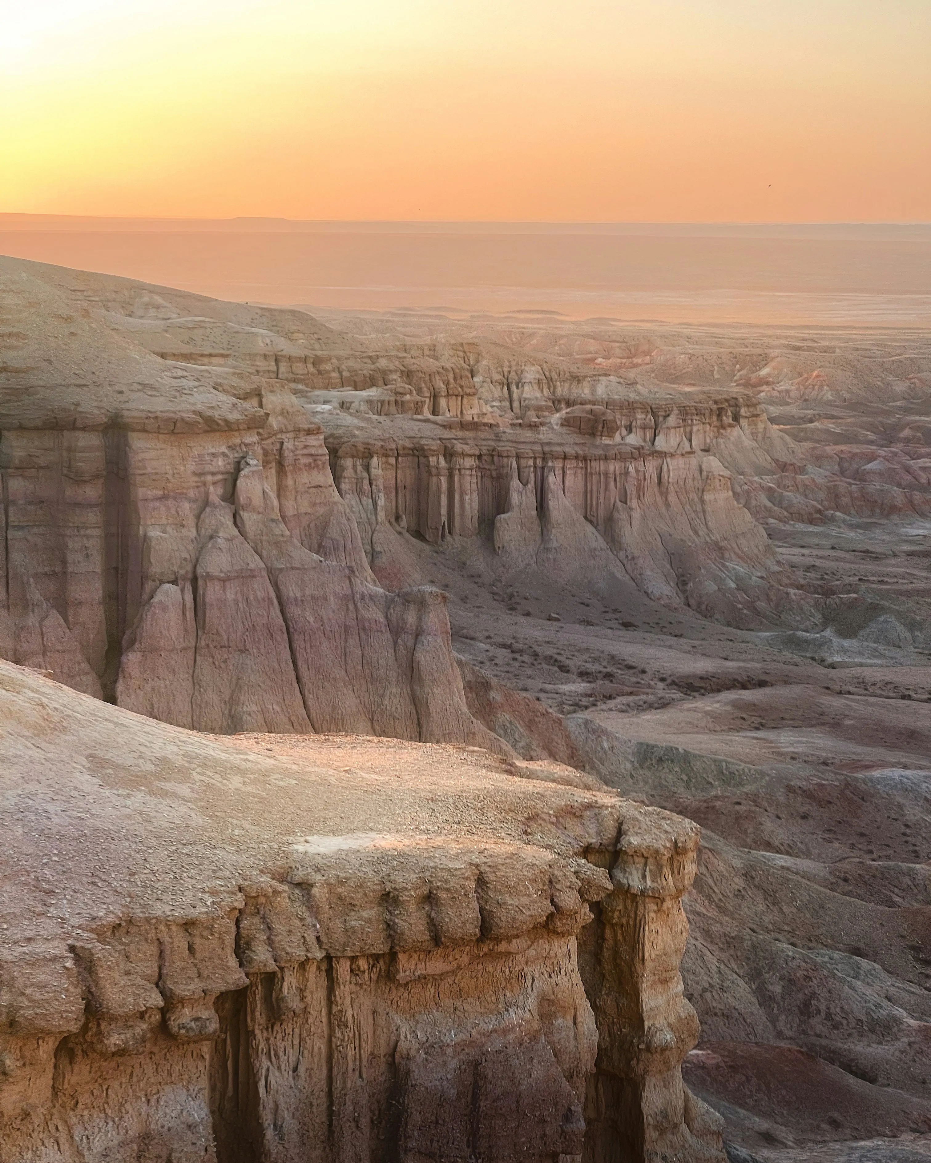 Tsagaan Suvarga, or White Stupa, is a striking geological formation in Mongolia's Gobi Desert, featuring towering limestone cliffs with distinctive white and red layers.