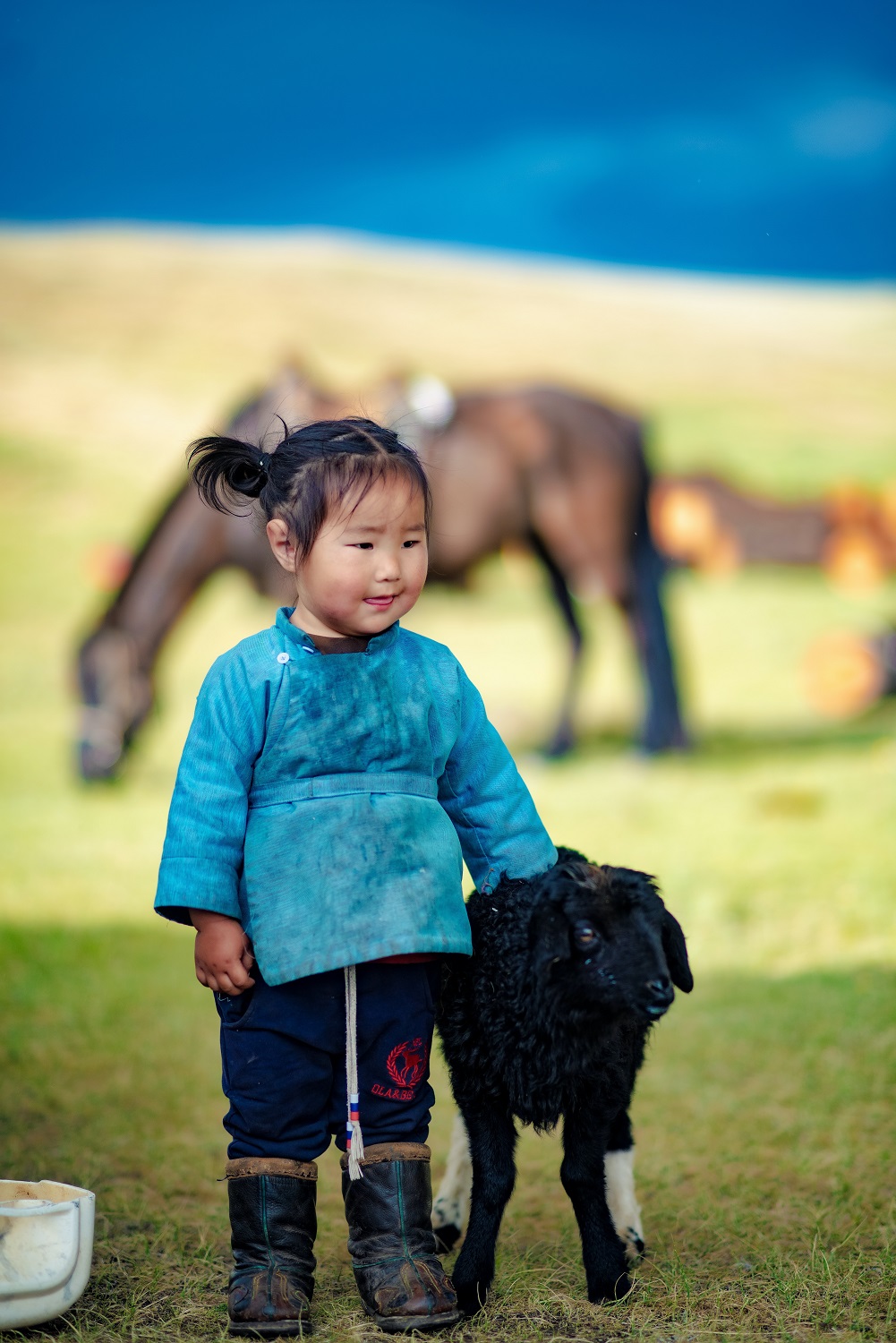 Mongolia, nomadic girl standing | Nomadic family visit