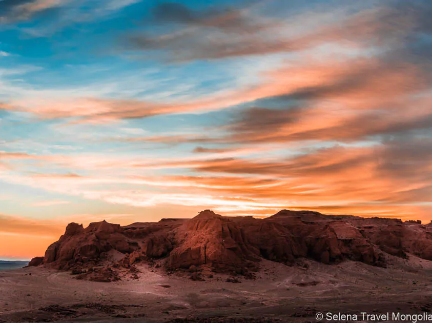 Sunset over the Flaming Cliffs at Bayanzag, famous for dinosaur fossil discoveries in Mongolia.